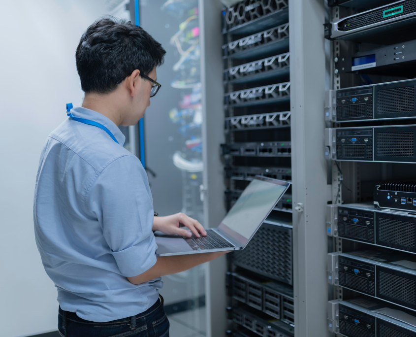 Computer engineer is setting up network in server room