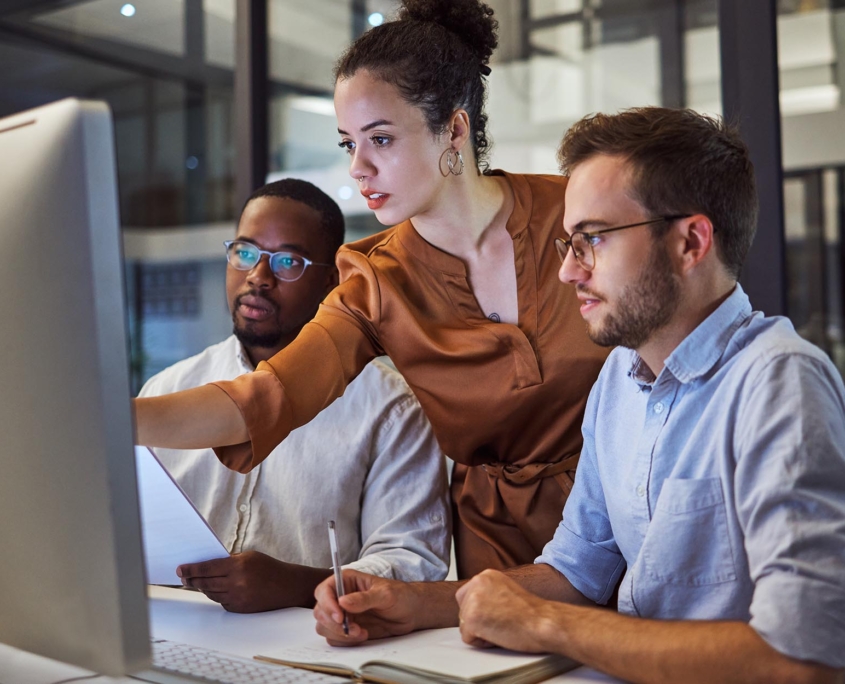 Tech professional helping other workers with their computer