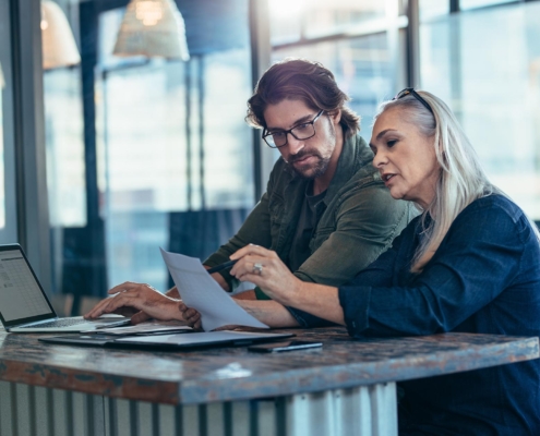 Two people talking in office