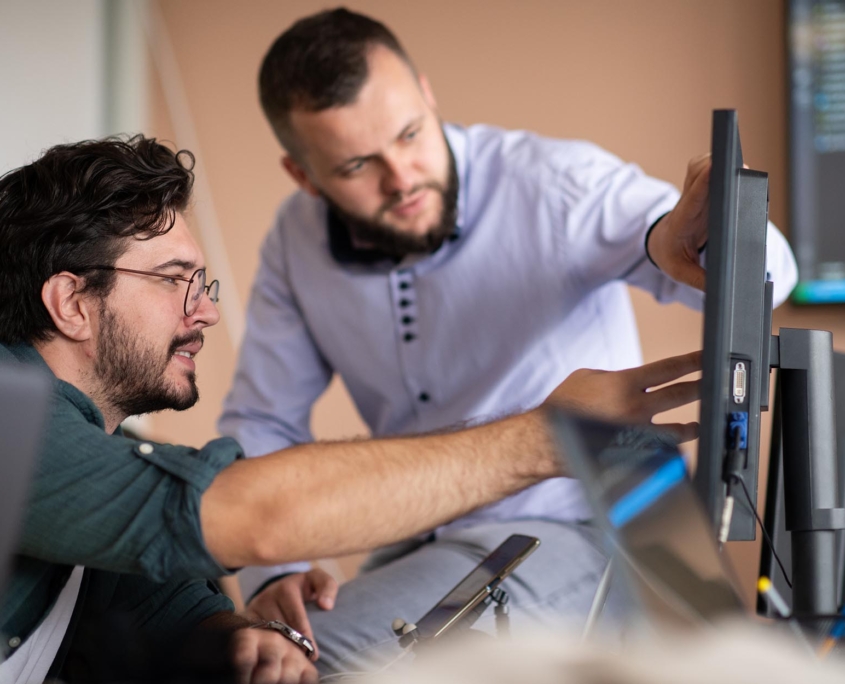 Two workers looking at computer in office